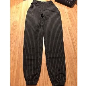Black striped trousers (right at ankles)